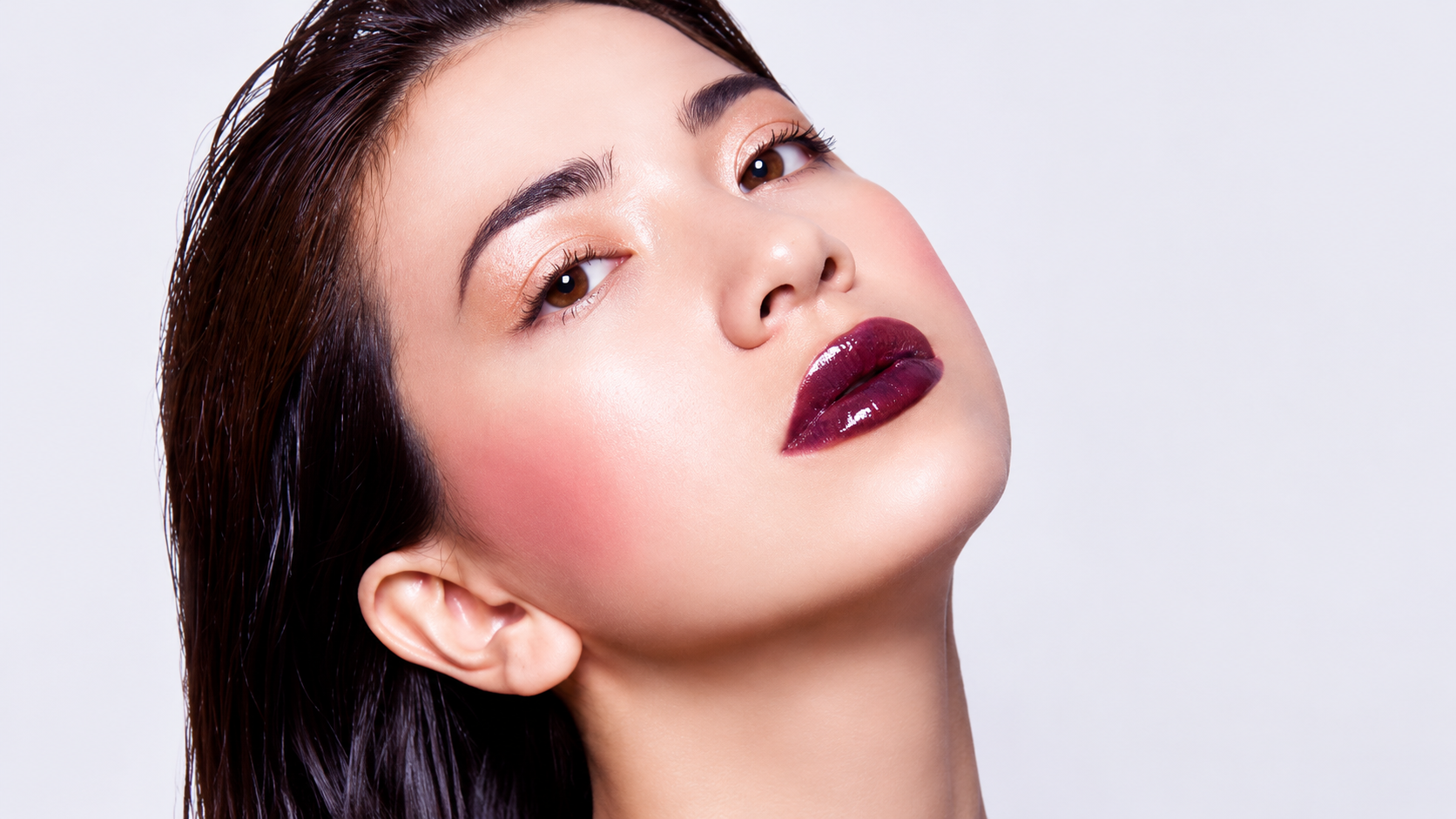 Young women posing to highlight their facial contours for Trinity Volume Contouring.