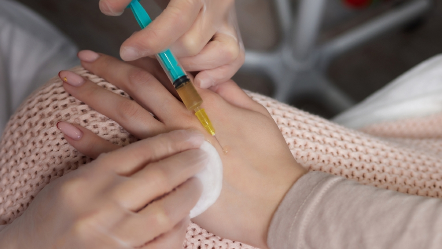 Doctor doing stem cell therapy on patient elbow