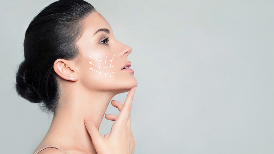 Woman in profile touching her chin, with white lifting arrows and lines overlaid on her cheek.