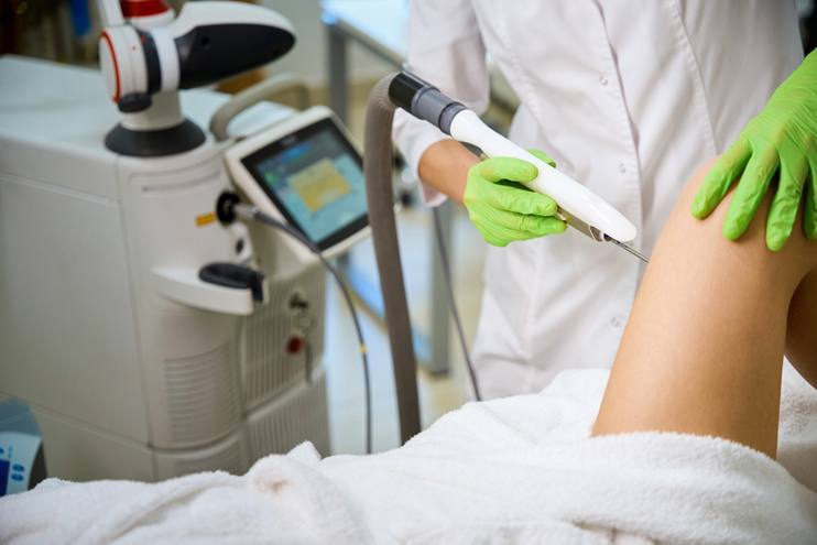 Medical professional performing triple vaginal rejuvenation surgery using advanced surgical equipment
