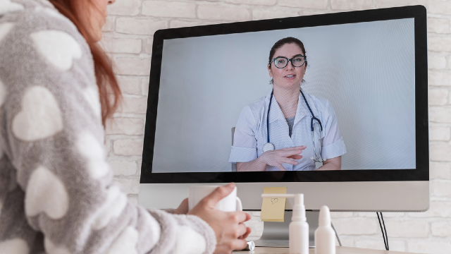 Patient participating in a virtual telehealth consultation with a doctor