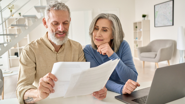 Couple reviewing medical records and medication lists to share with the clinic before booking travel
