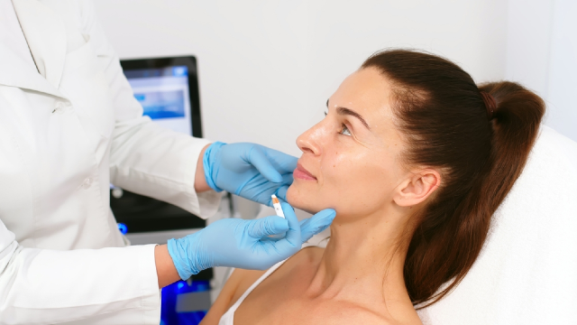 Collagen stimulator injectable treatment for facial volume restoration performed by a medical professional