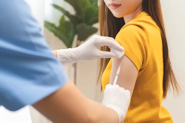 Patient receiving vaccination as part of a safe and supervised medical care process